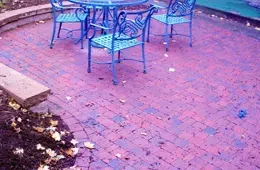 A table and chairs on a brick patio.