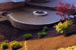 There is a fire pit in the middle of the patio.