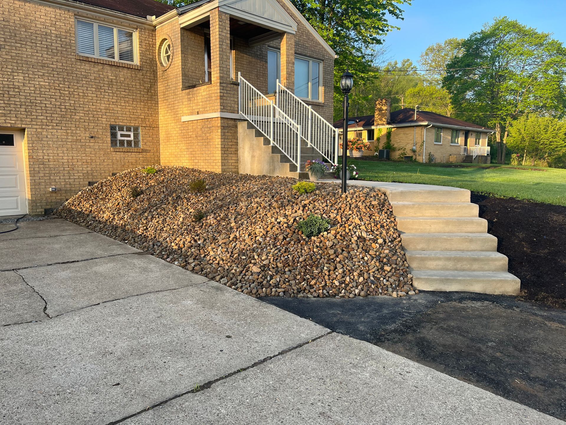 A brick house with stairs leading up to the front door