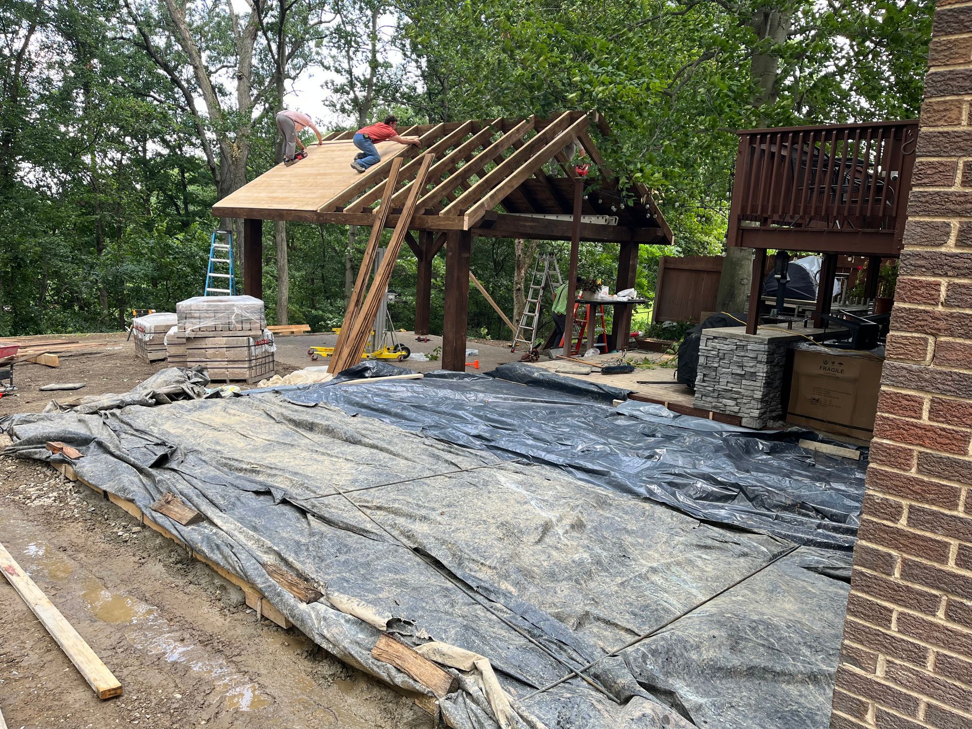 A pavilion is being built in the backyard of a house.