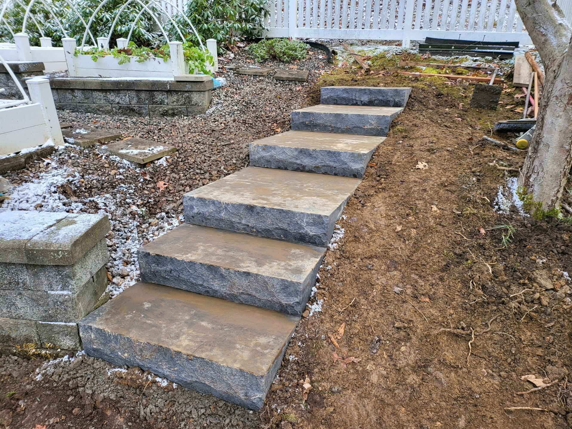 A set of stairs leading up to a fountain in a garden.