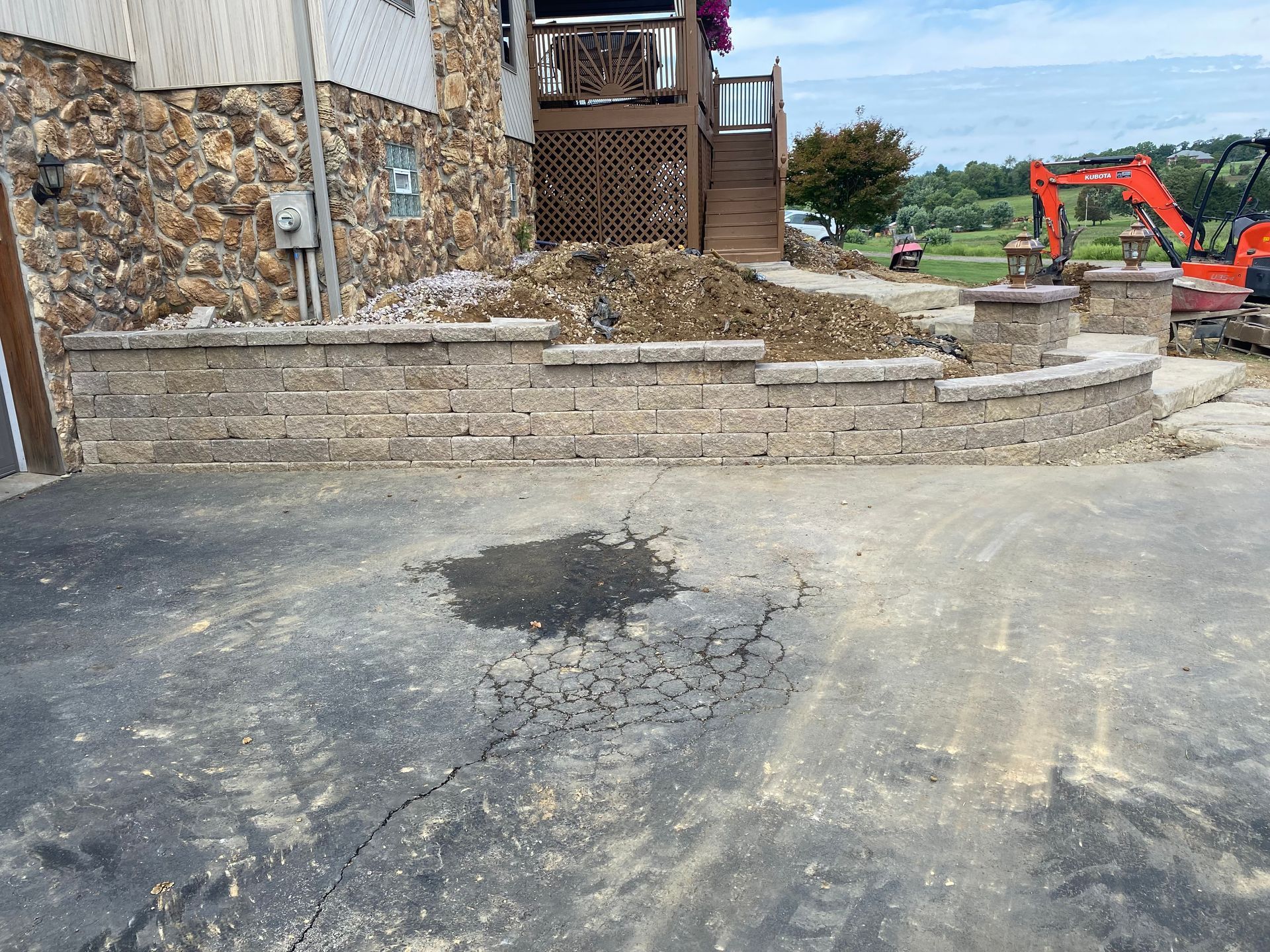 A brick wall is being built in front of a house.