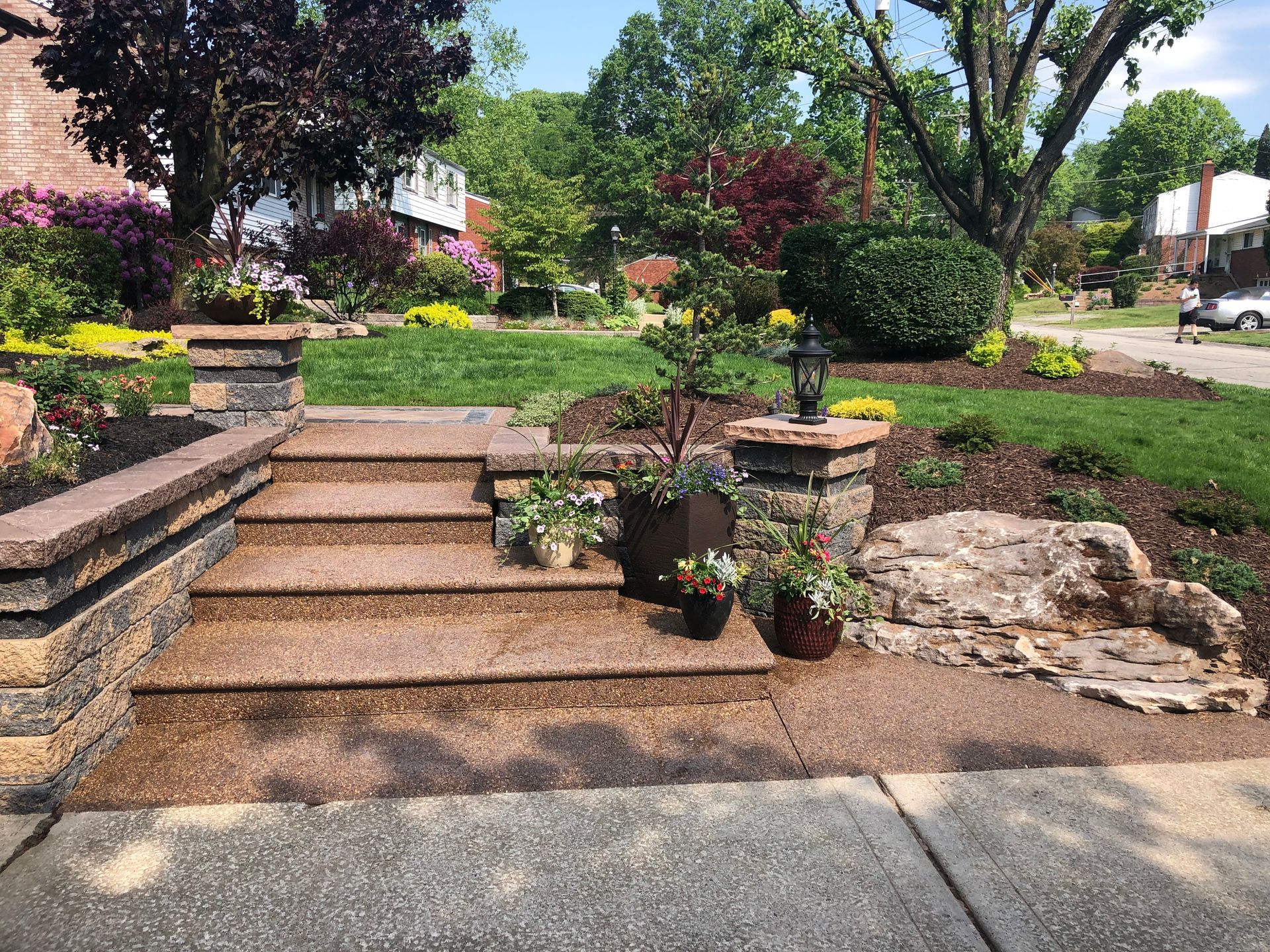 A set of stairs leading up to a lush green yard.