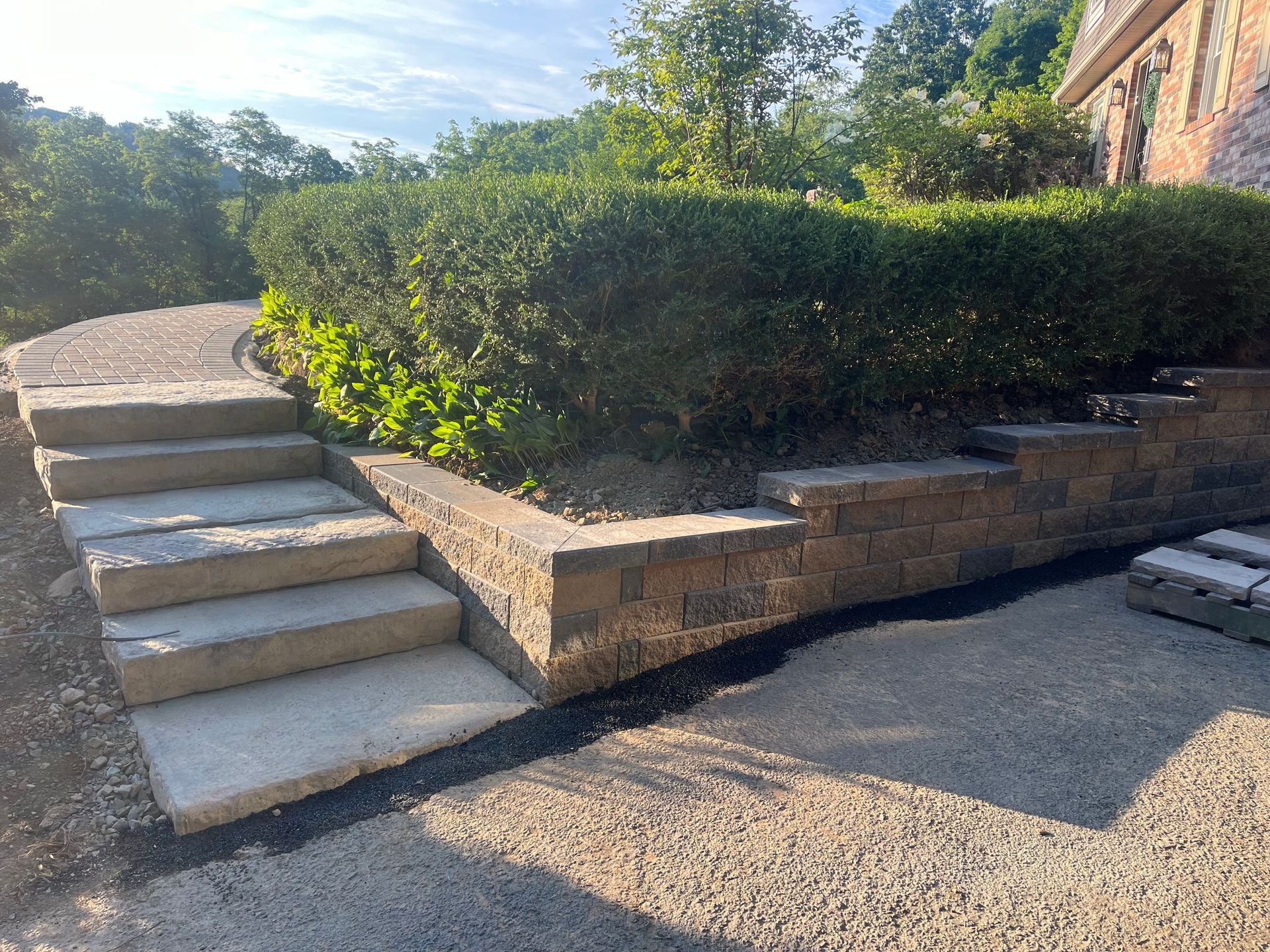 A set of stairs leading up to a brick wall.