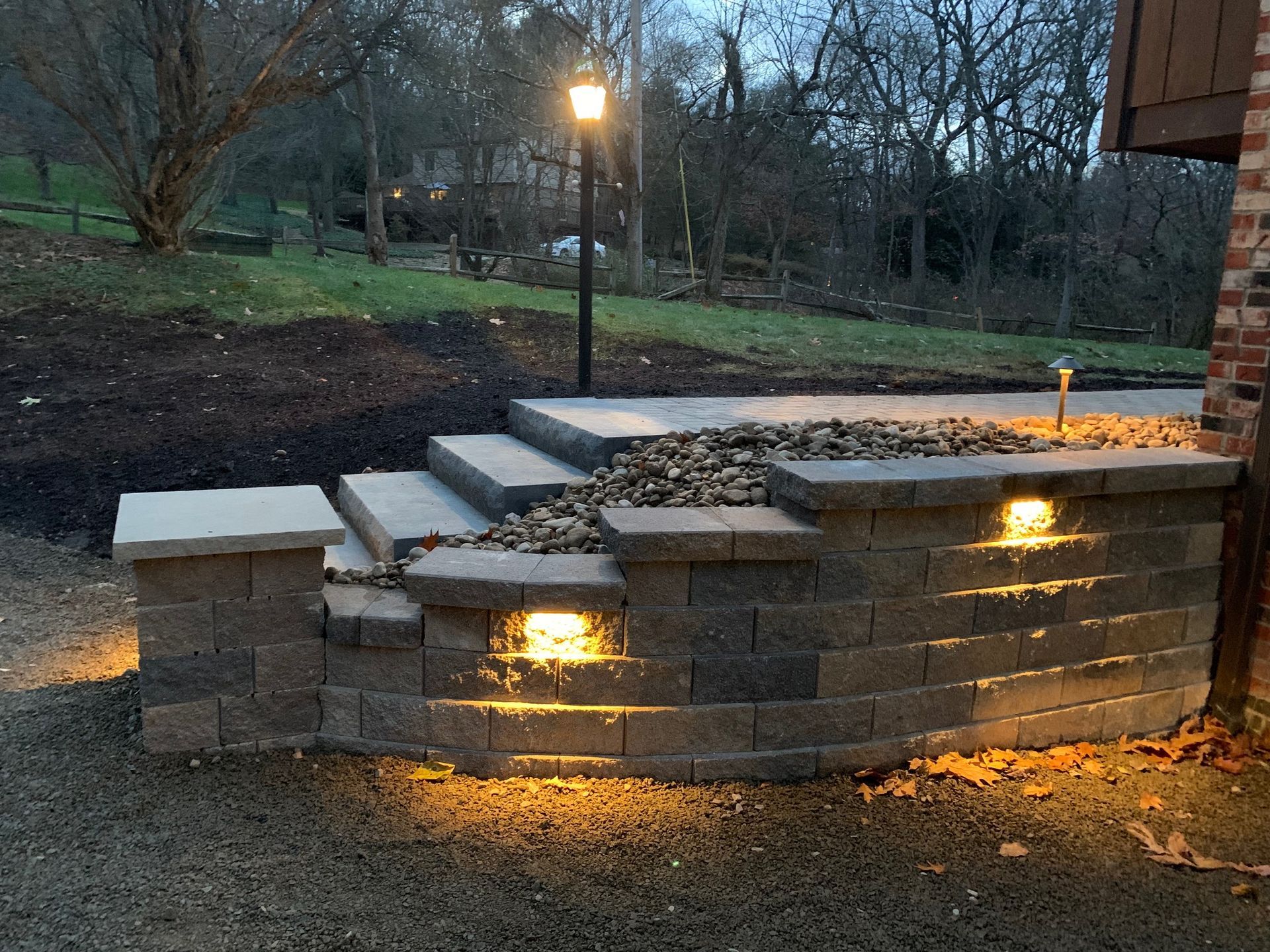 A brick wall with stairs and lights on it