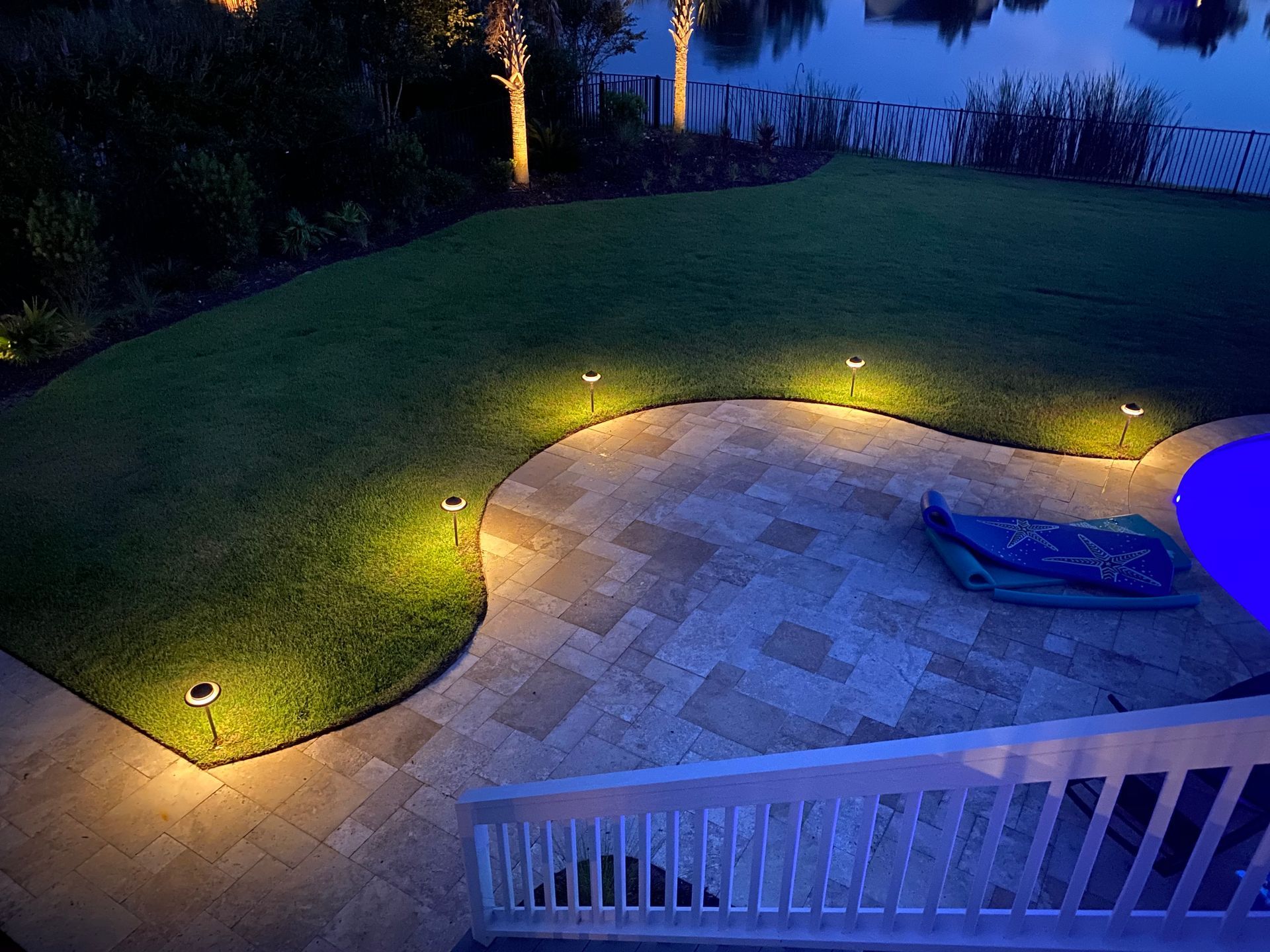 An aerial view of a patio with lights on at night.