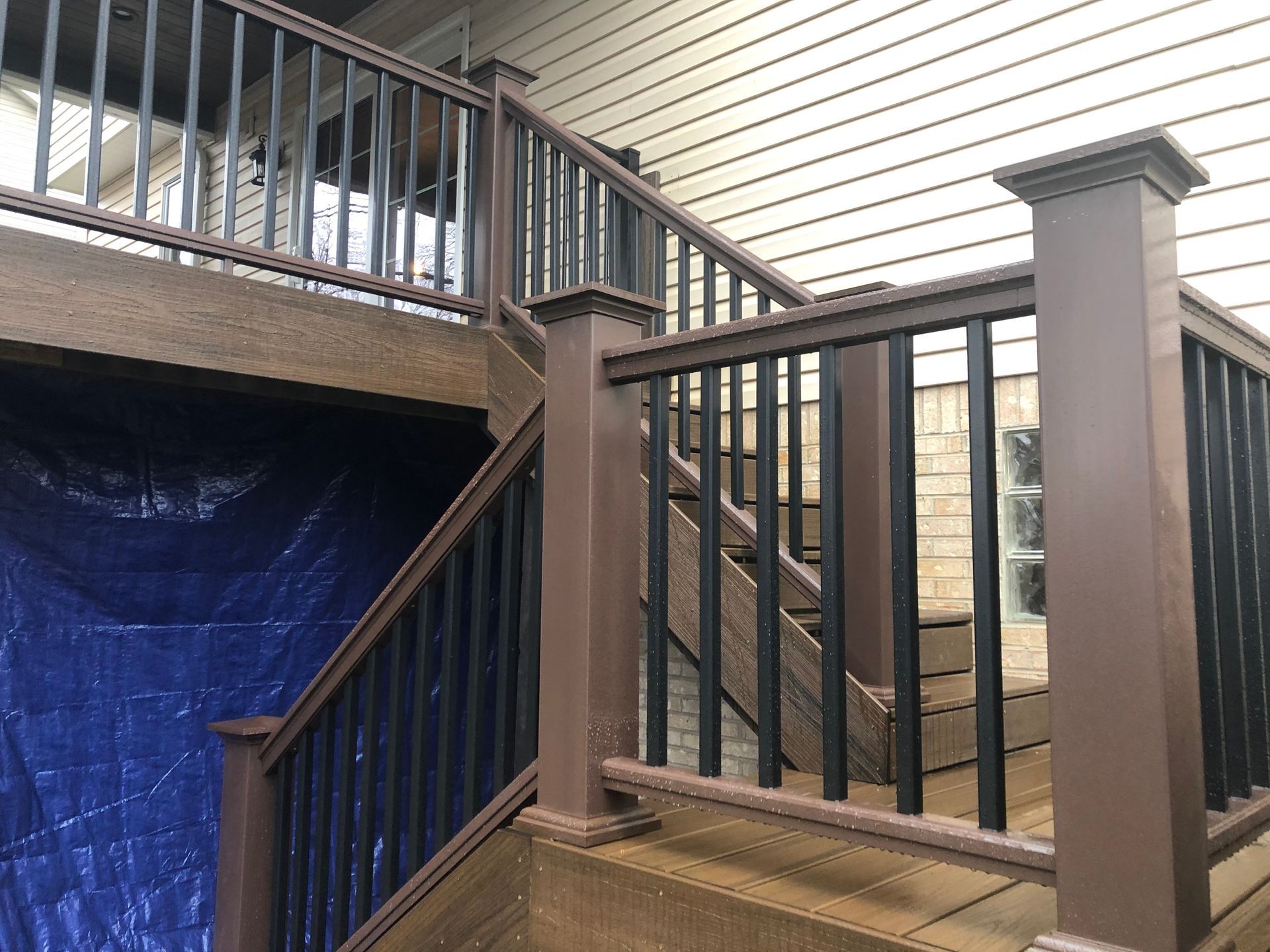 A close up of a deck with stairs and a railing.