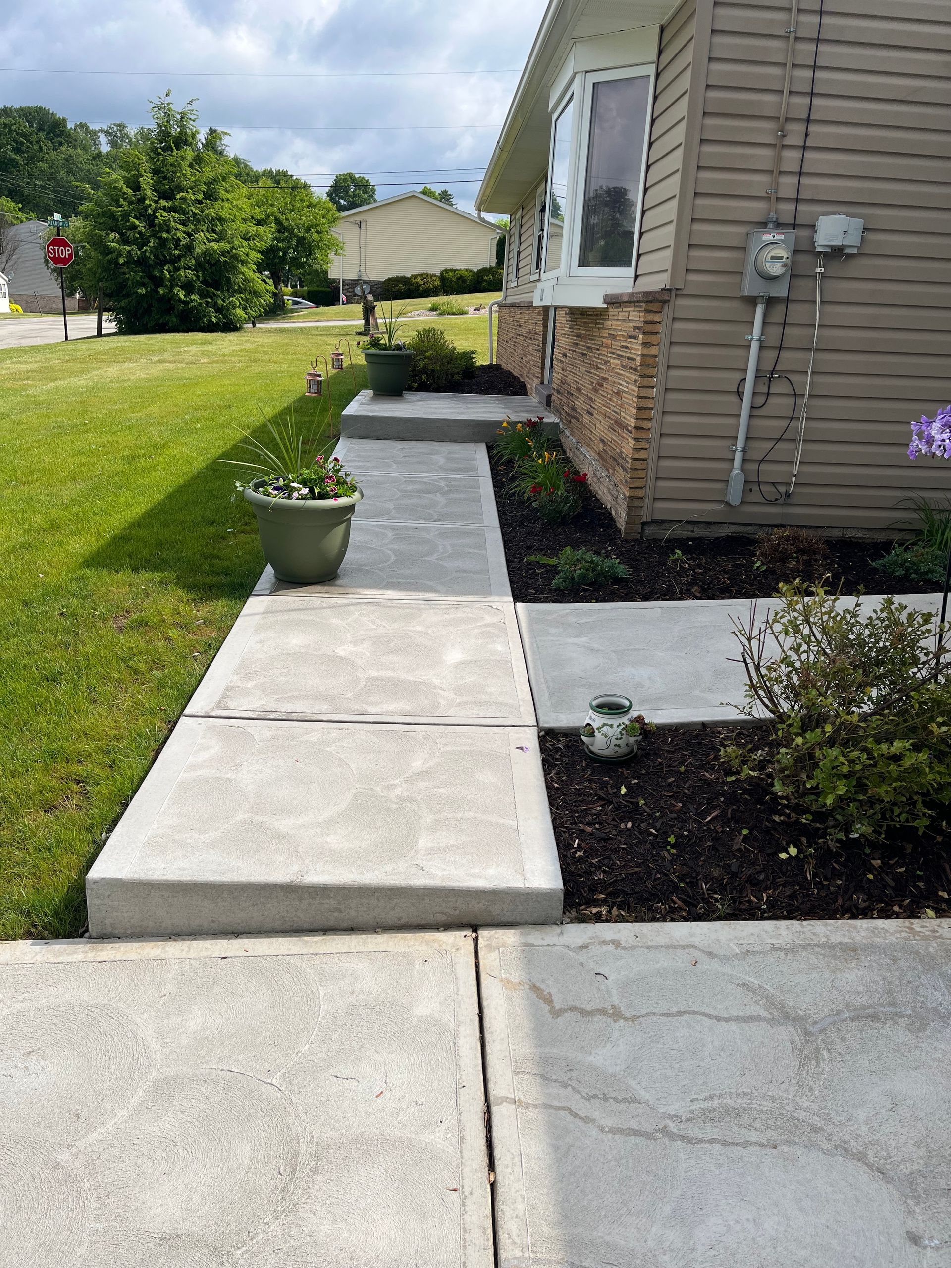 A house with a concrete walkway leading to it