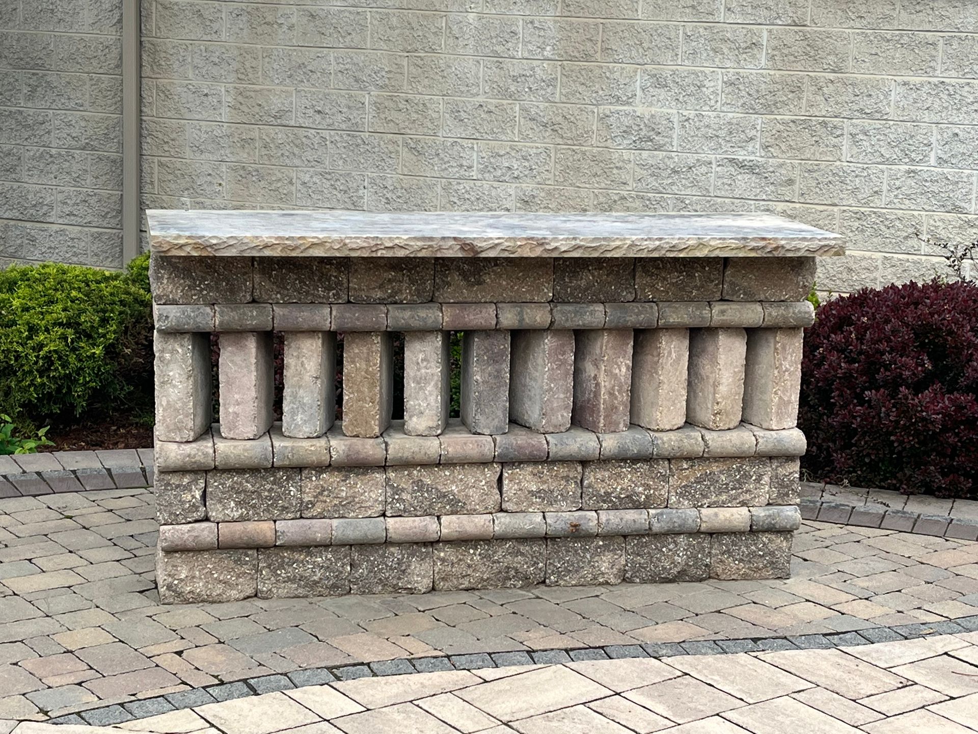 A stone block with a brick wall in the background