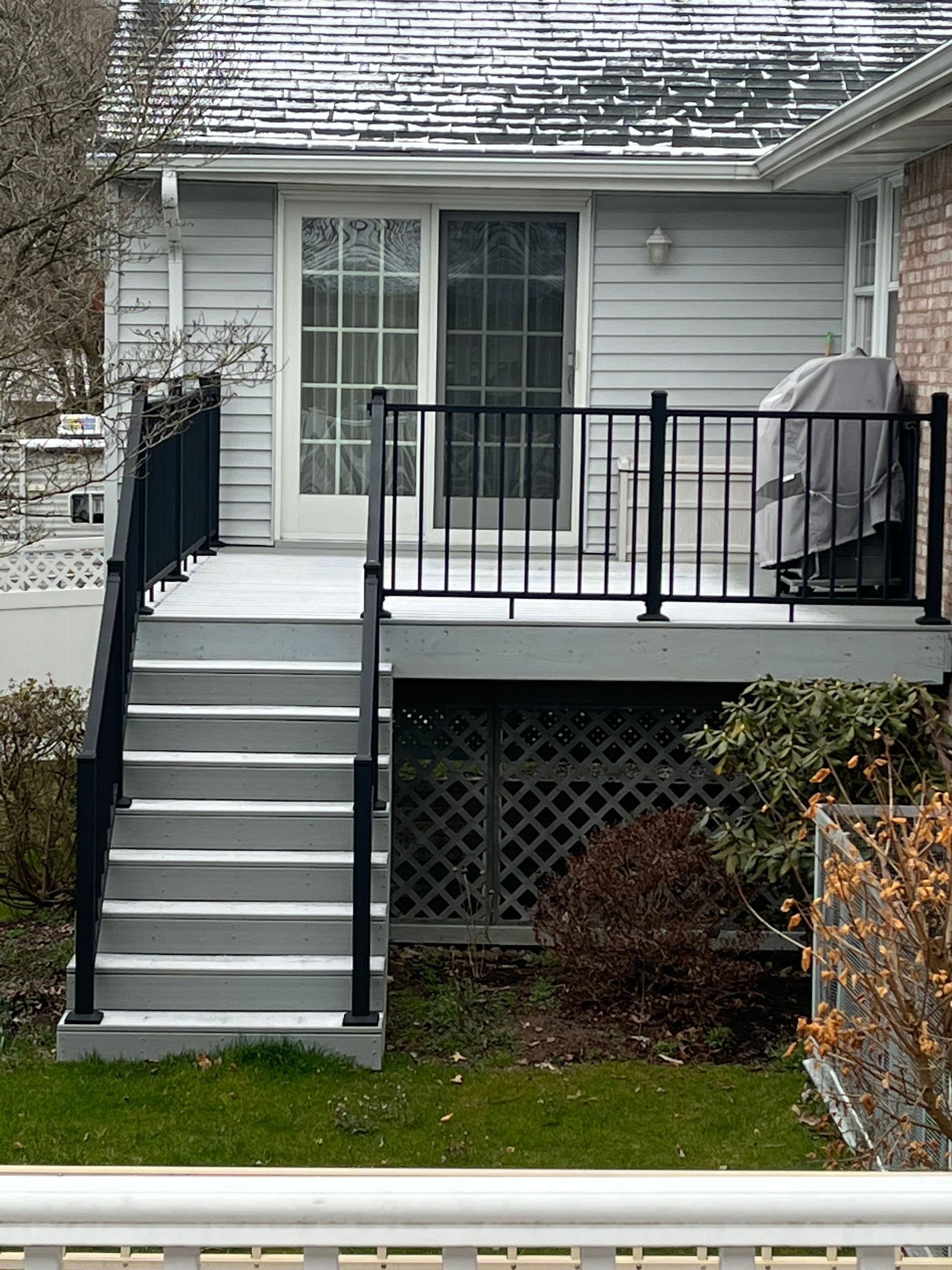 A house with a deck and stairs leading up to it