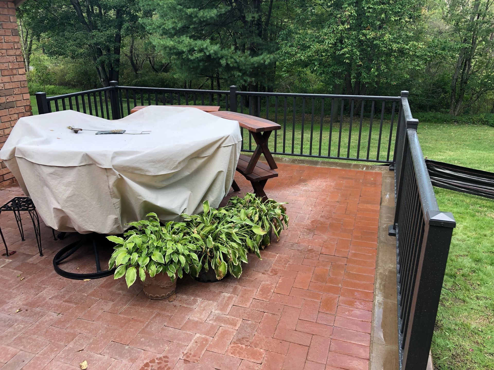 A patio with a table and chairs and a cover on it