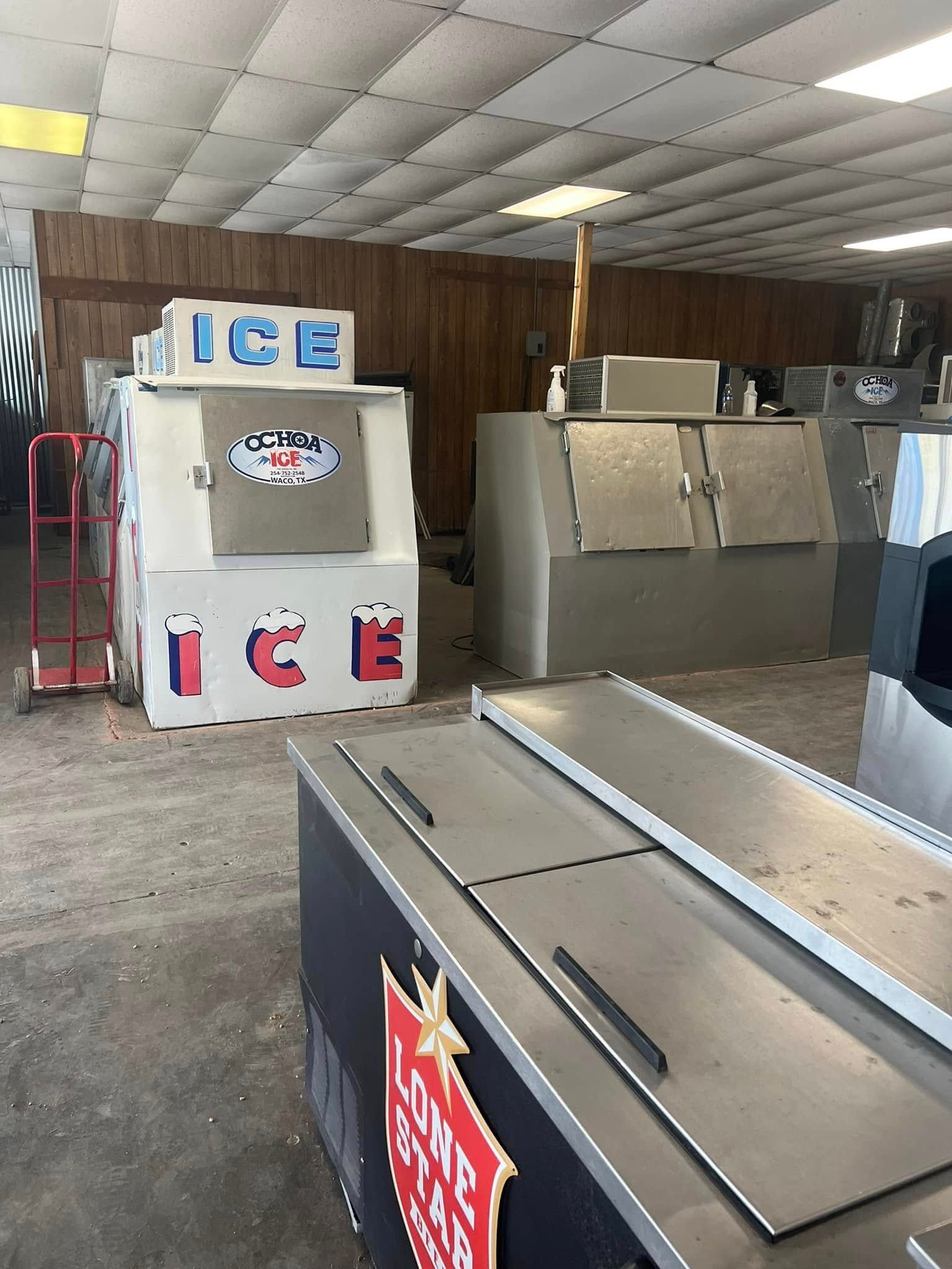 A warehouse filled with ice machines and a sign that says ice