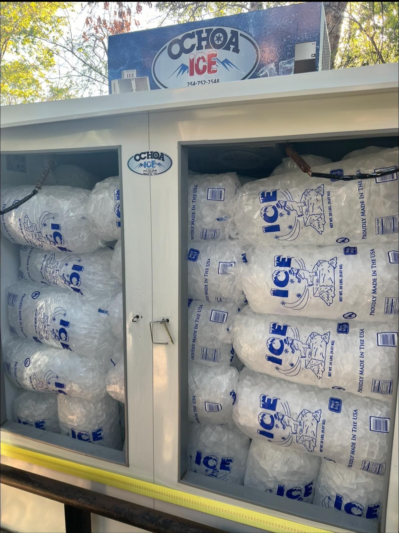 A truck filled with bags of ice and a sign that says ochoa ice.
