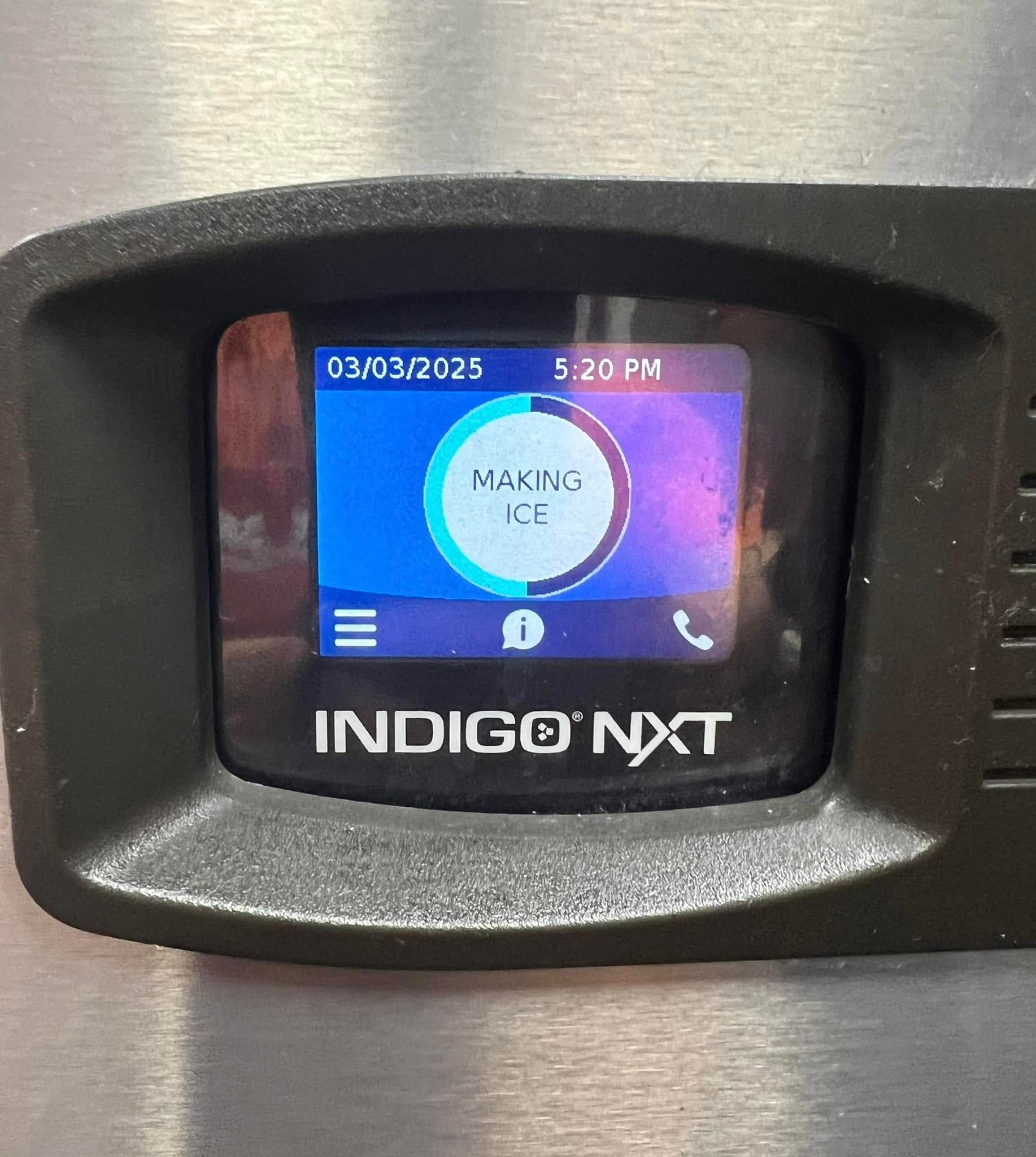 A close up of a indigo nxt device on a wall