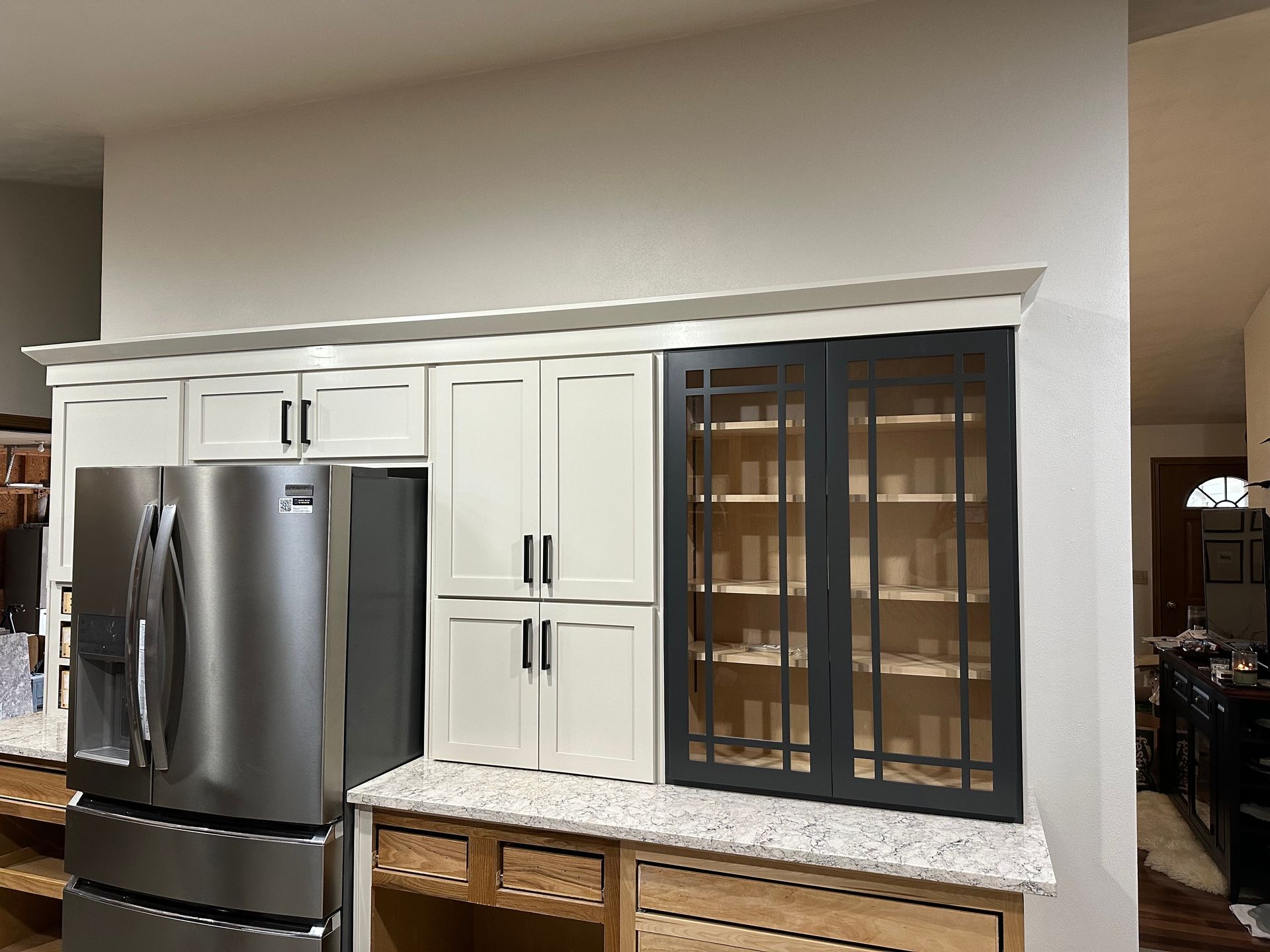 A kitchen with stainless steel appliances and white cabinets.