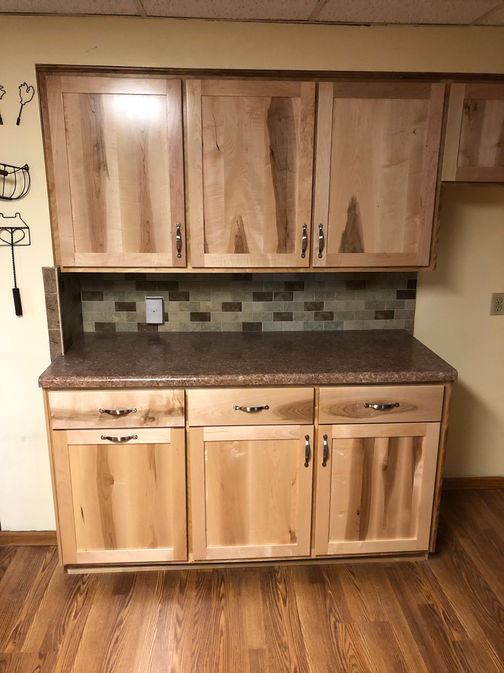 A kitchen with wooden cabinets and a granite counter top