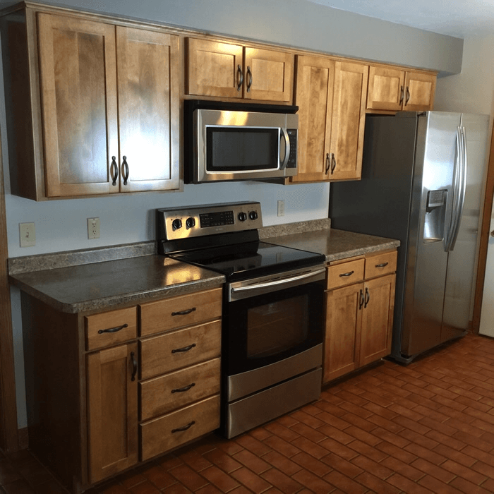 A kitchen with stainless steel appliances and wooden cabinets