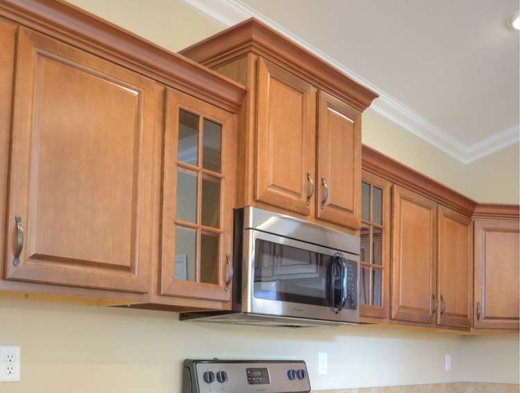 A kitchen with stainless steel appliances and wooden cabinets