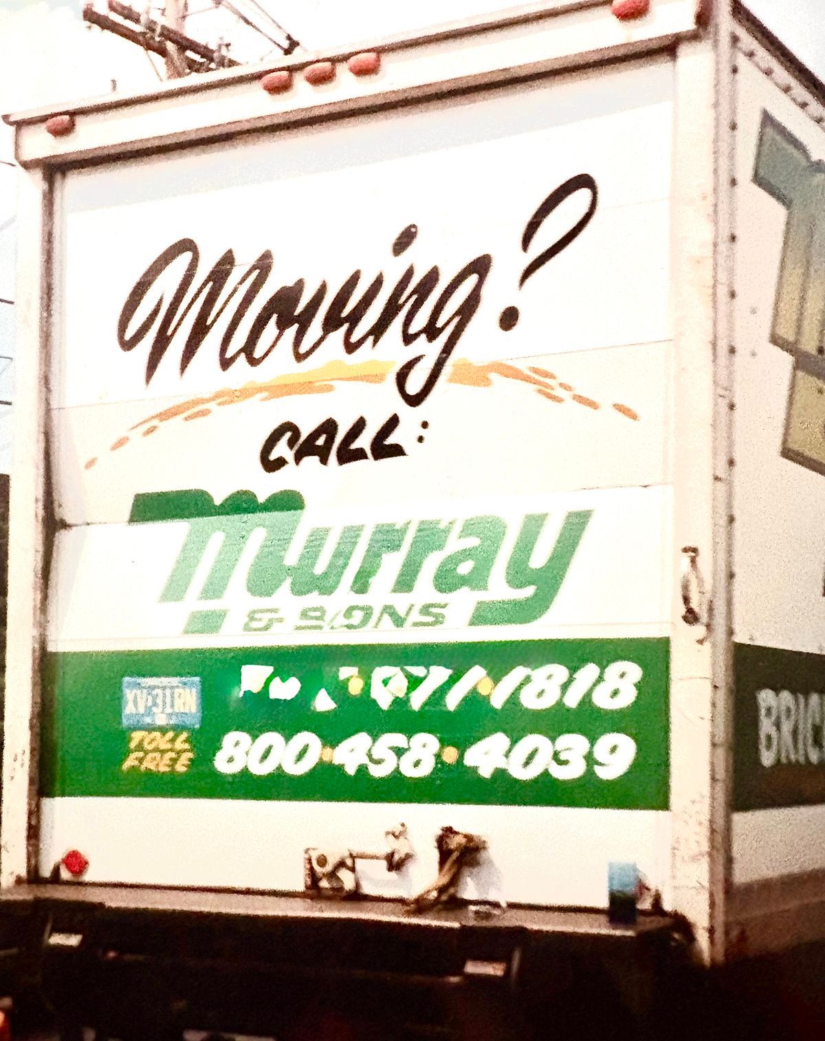 Moving truck with Murray Express logo and phone numbers on the back door.