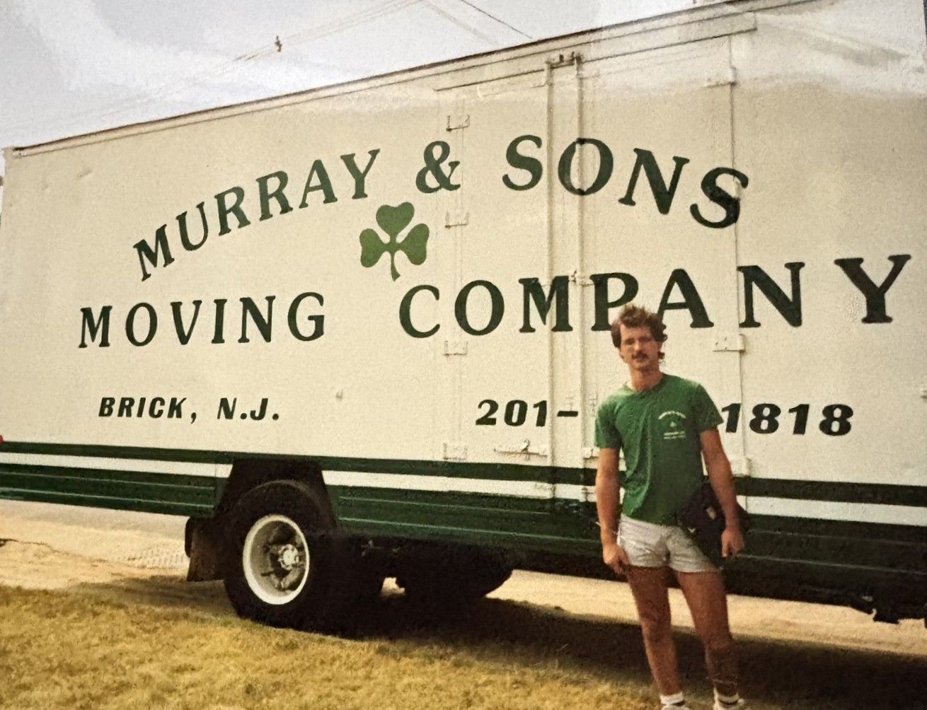Man standing beside a Murray & Sons Moving Company truck in Brick, NJ