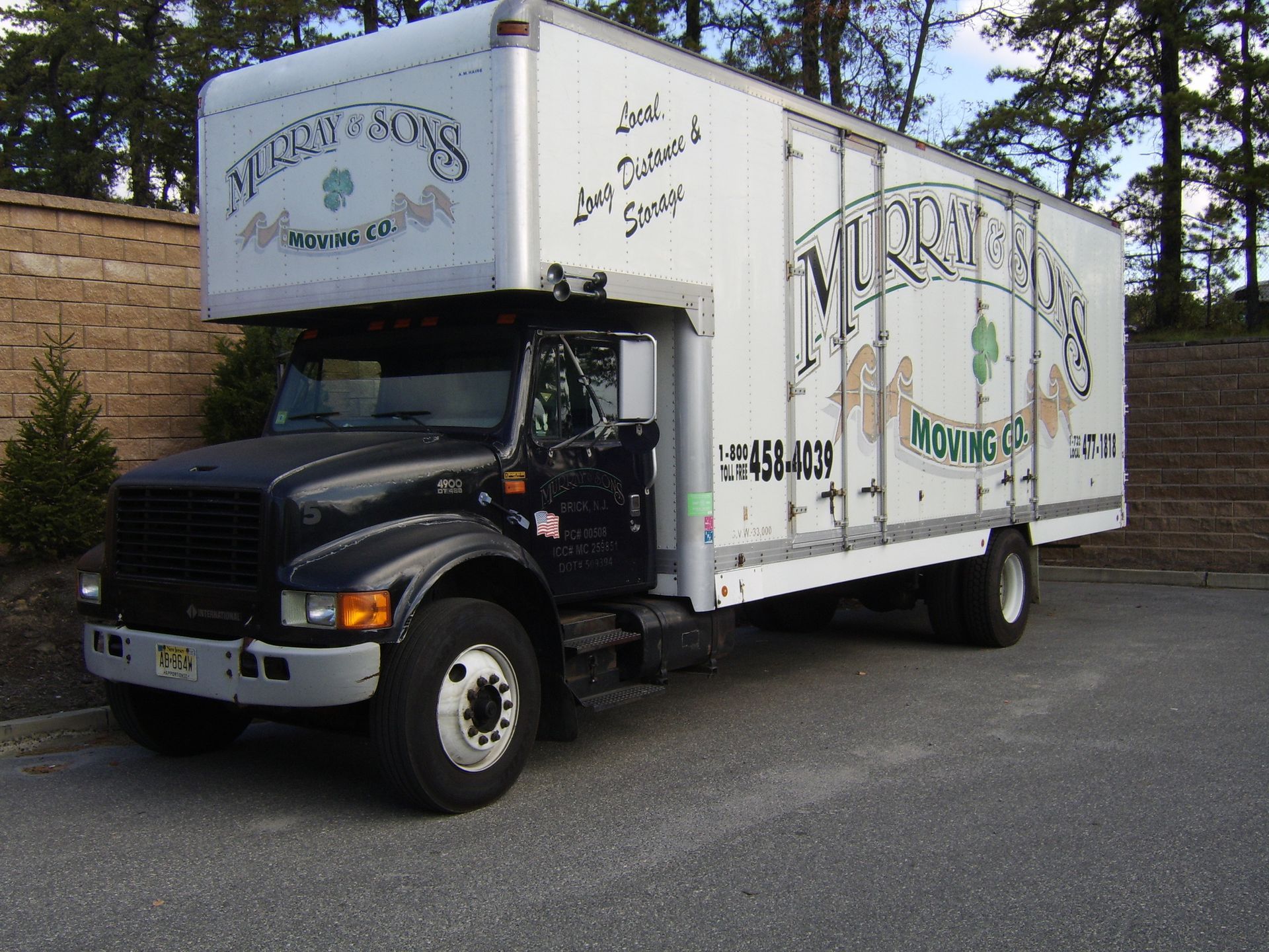 White moving truck parked outdoors with “Miller” branding on the side.