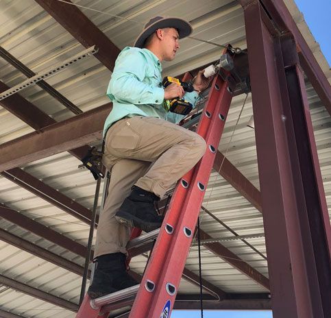 A man is installing a CCTV