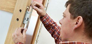 Locksmith installing the doorlock