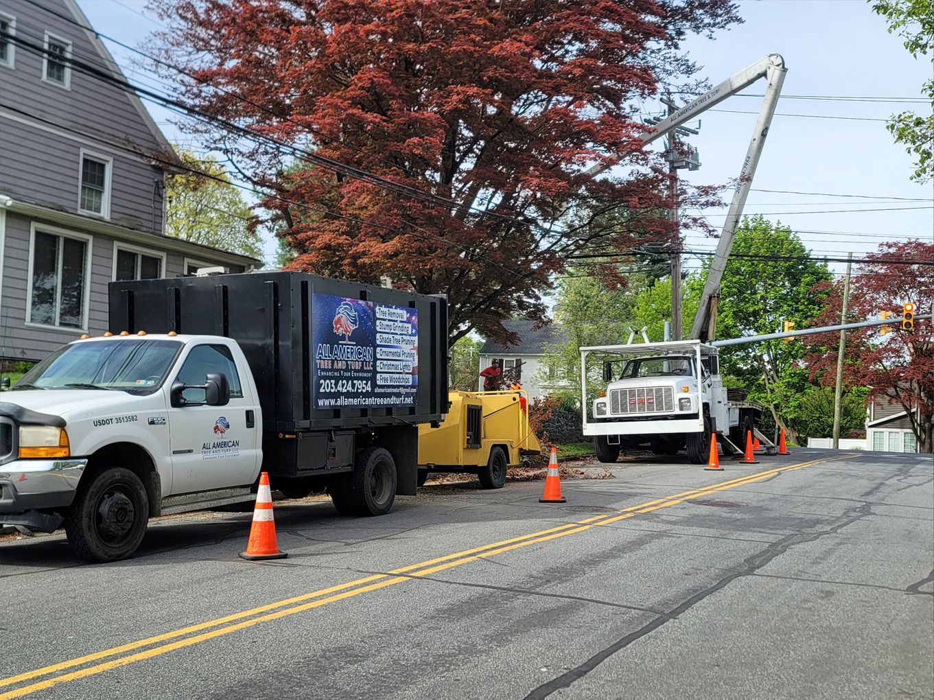 Two trucks are parked on the side of the road.