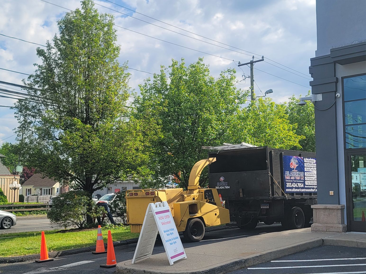 A tree chipper is parked in front of a building.