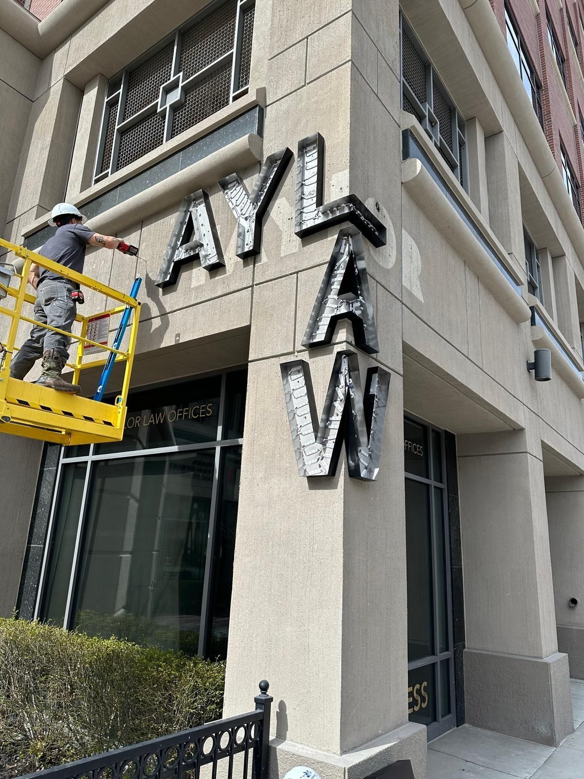 Man in lift painting 