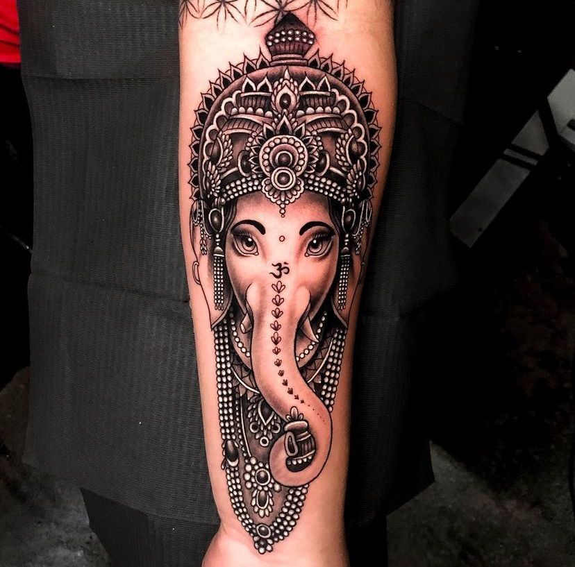 a tattoo of an elephant with a crown on its head