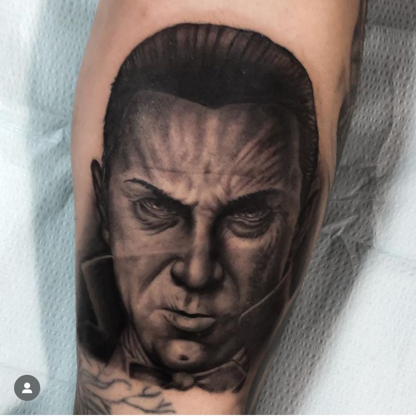 a black and white tattoo of a man's face