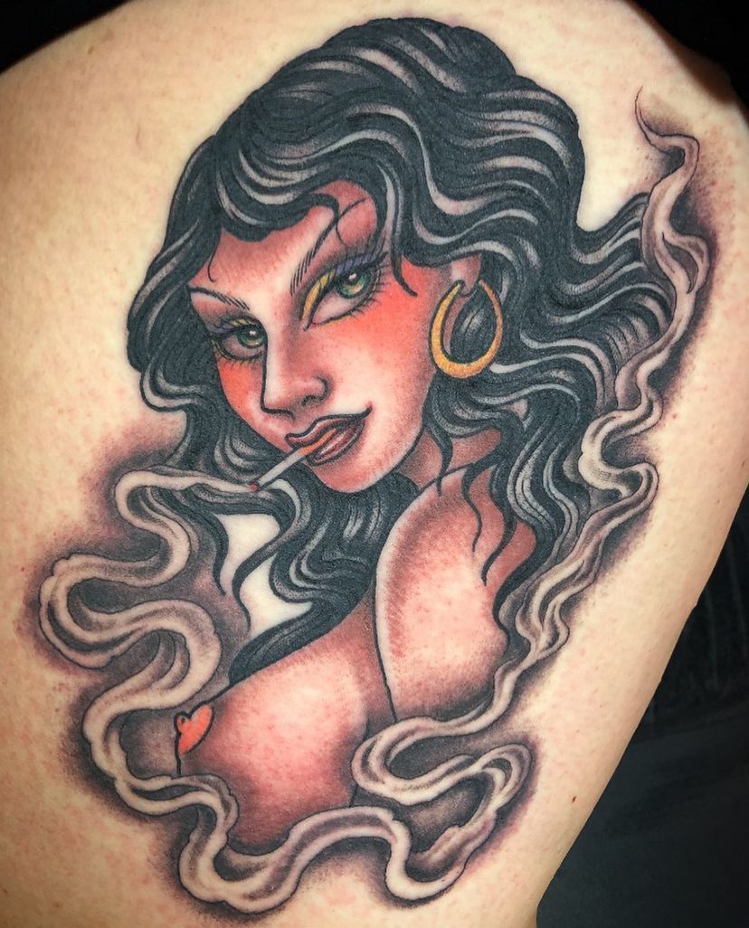 a tattoo of a woman with smoke coming out of her mouth