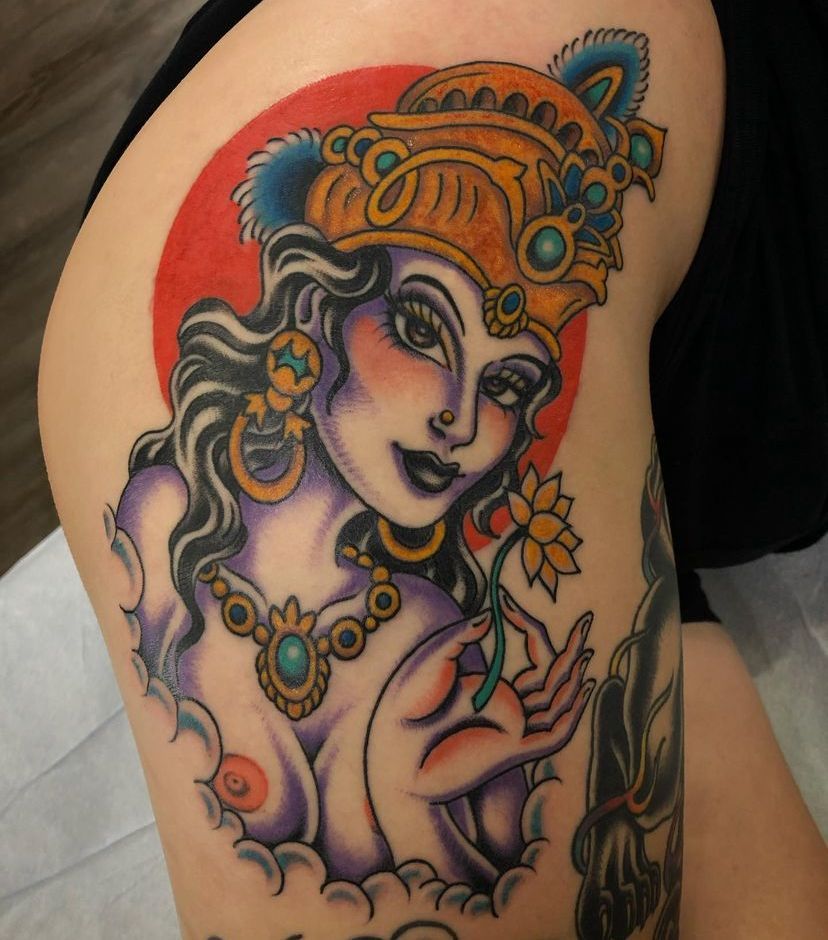 a woman has a tattoo of a woman holding a flower