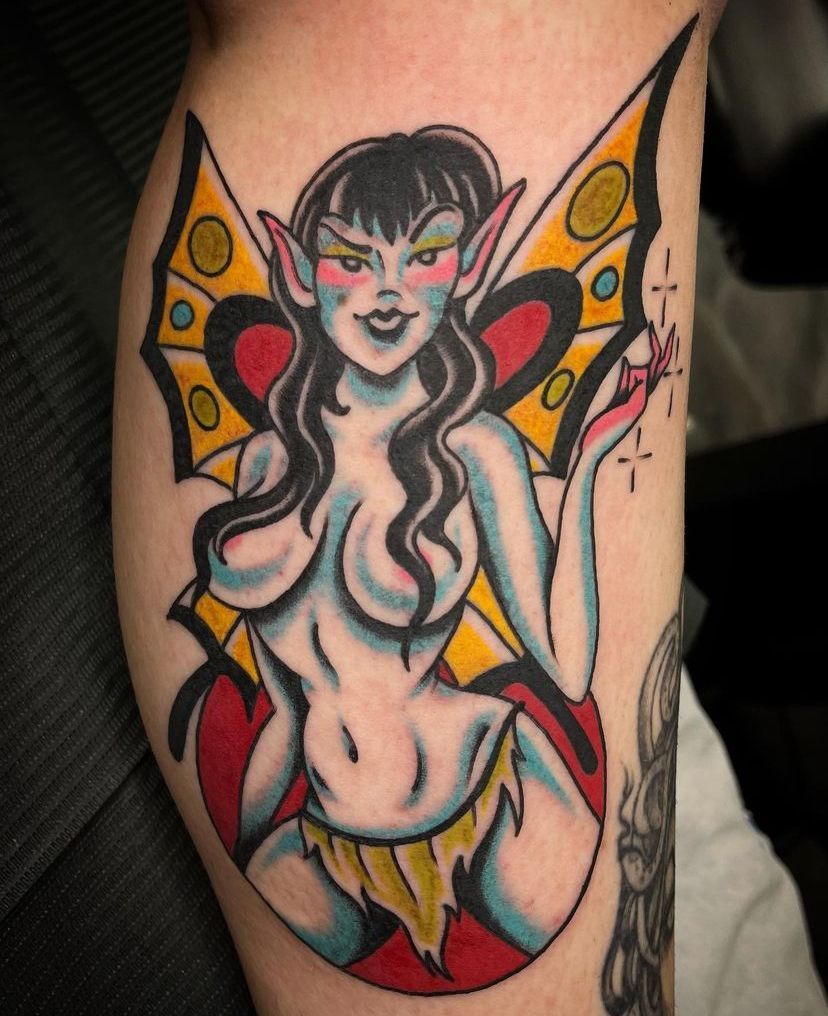 a tattoo of a woman with wings on her arm
