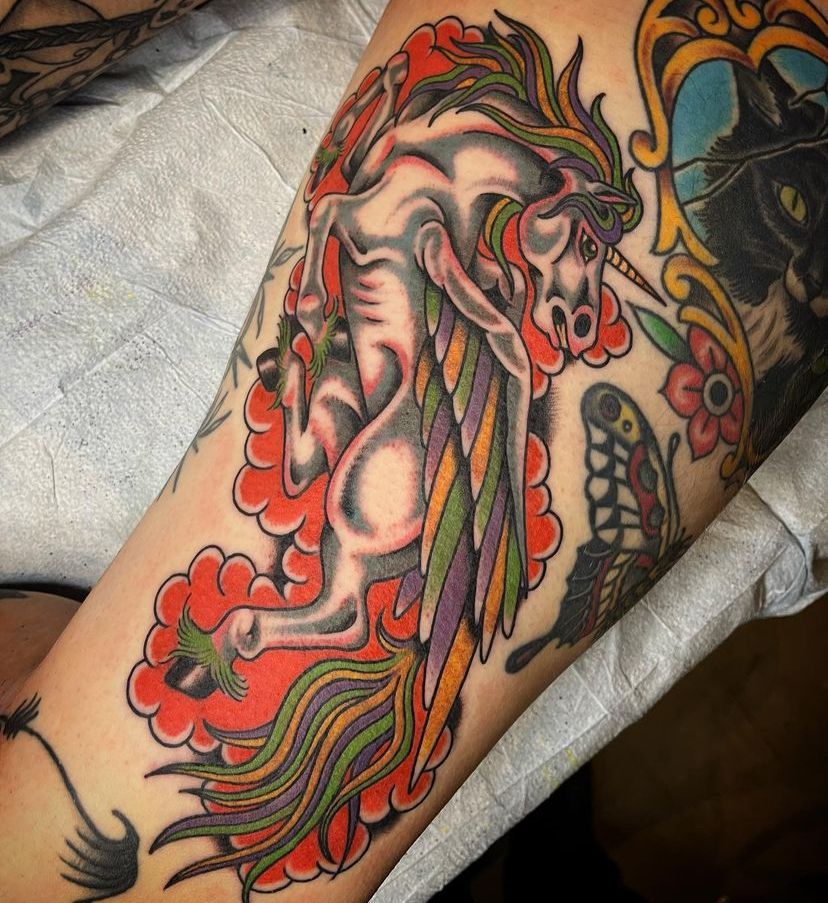 a tattoo of a unicorn on a person's arm