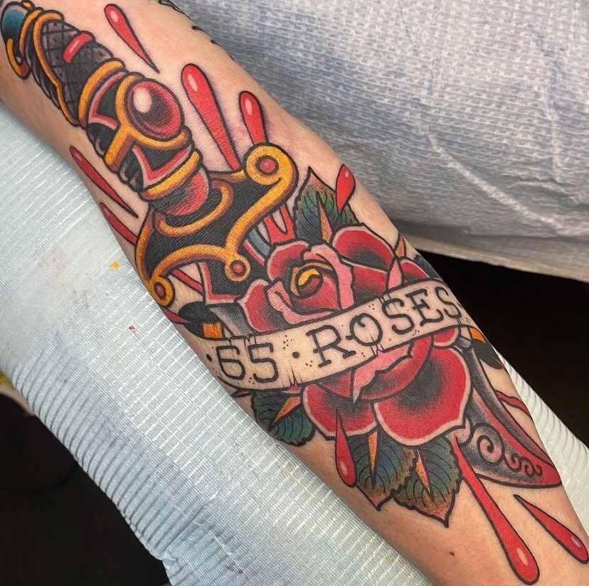 a tattoo on a person's arm that says 55 roses
