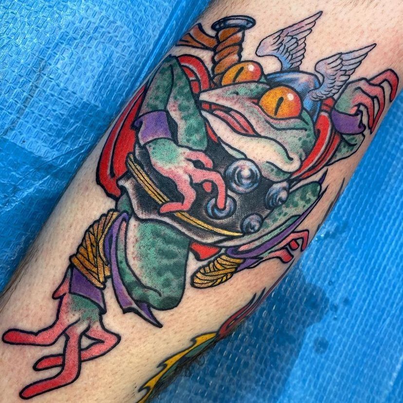 a tattoo of a frog with wings on its head