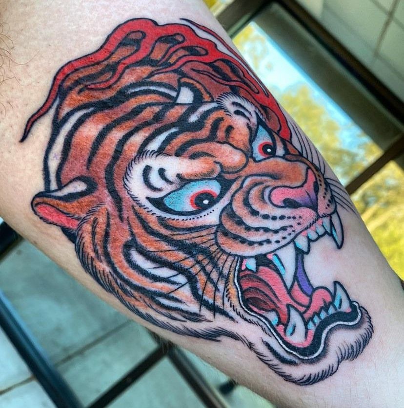 a tattoo of a tiger on a person's arm