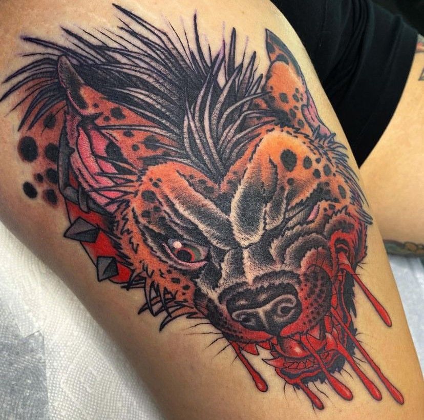 a tattoo of a hyena on a person's leg