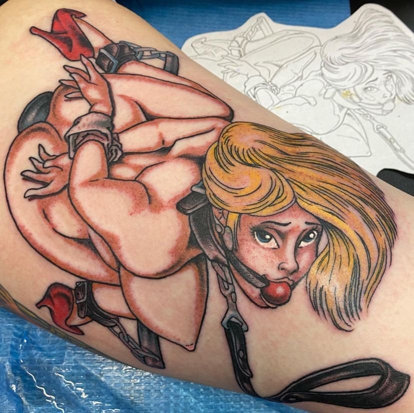 a tattoo of a girl tied up