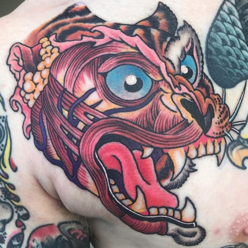 a tattoo of a tiger with a long tongue sticking out