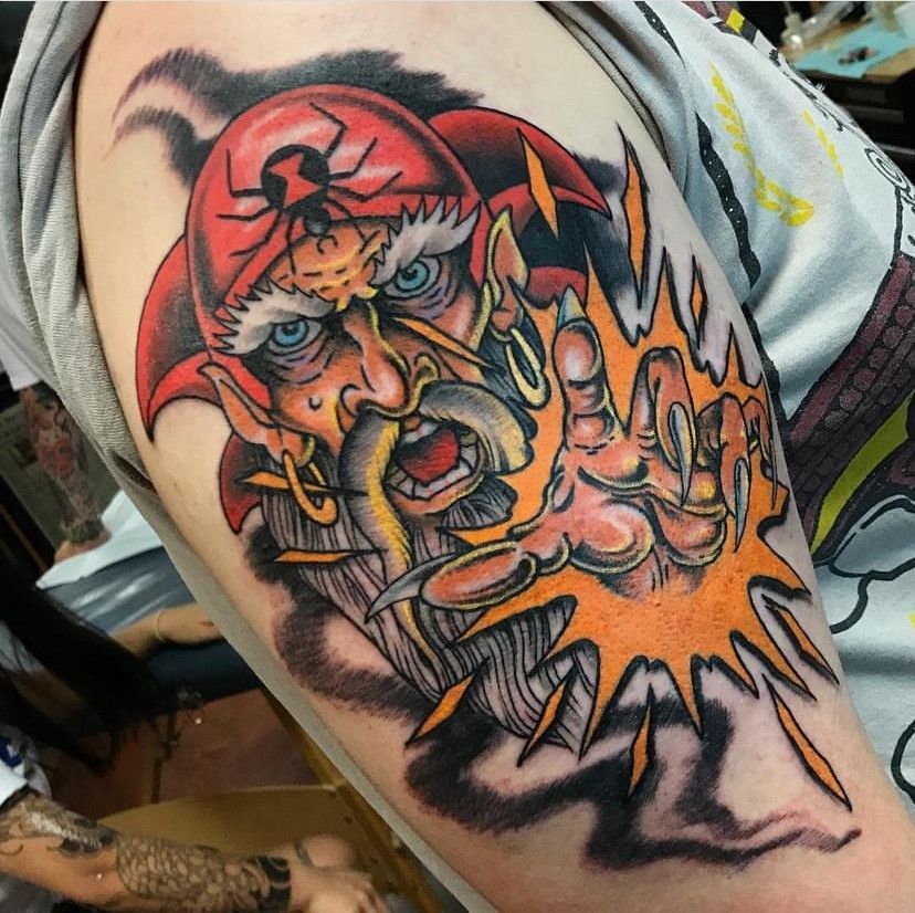 a man has a tattoo of a pirate on his arm