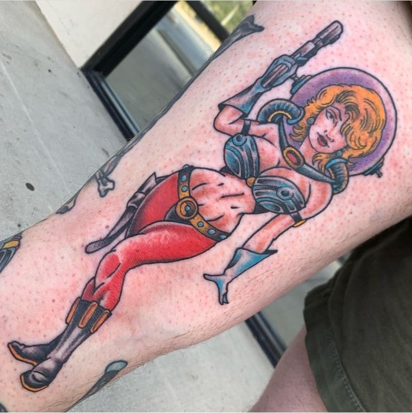 a tattoo of a girl in the arm of a person