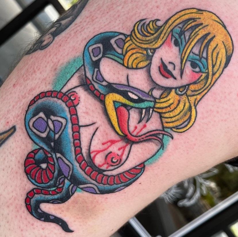 a tattoo of a woman with a snake around her neck