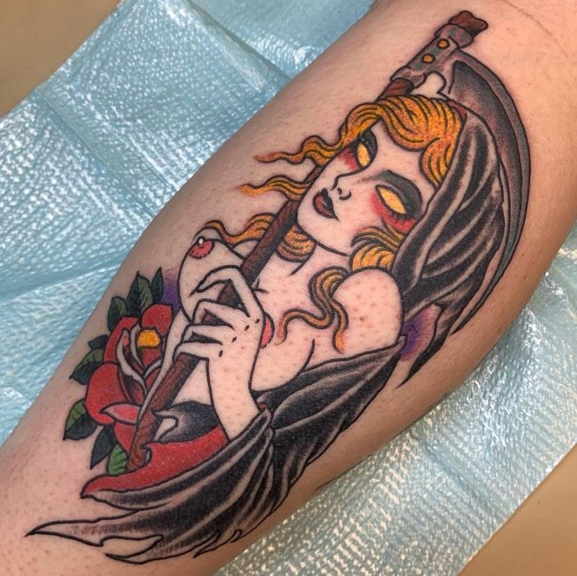 a tattoo of a woman with a scythe and a rose