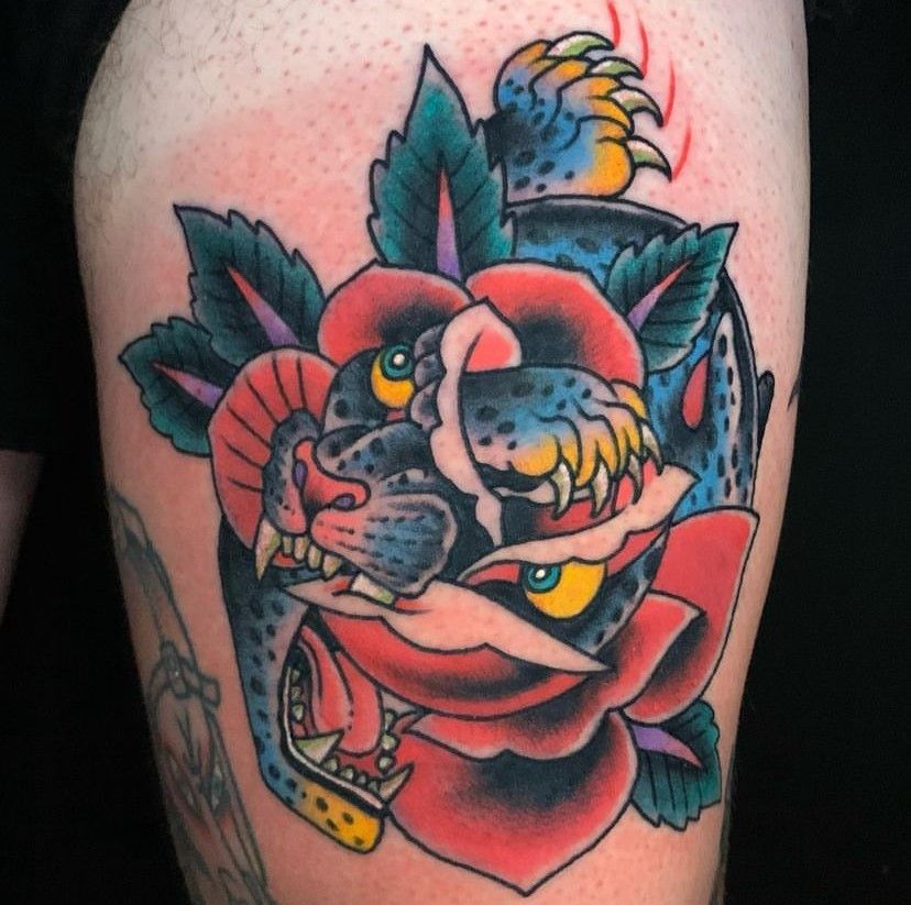 a tattoo of a leopard with a rose in its mouth
