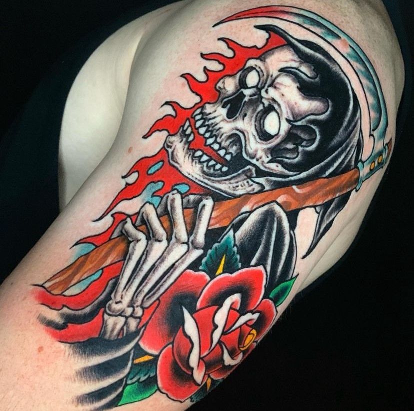 a tattoo of a grim reaper holding a scythe and a rose
