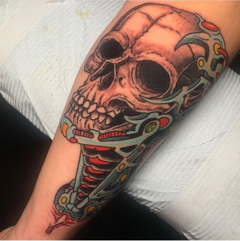 a tattoo of a skull on a person's arm