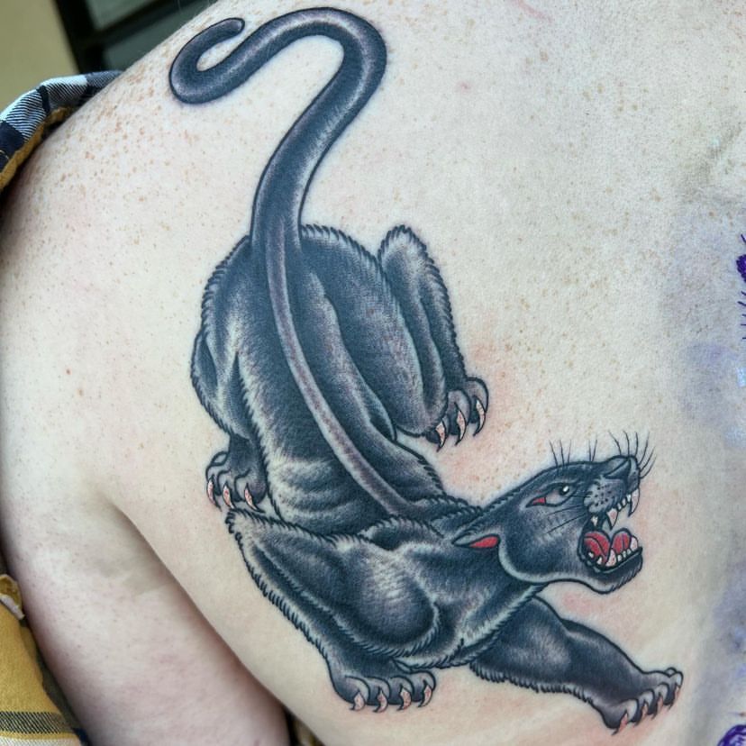 a person has a black panther tattoo on their back